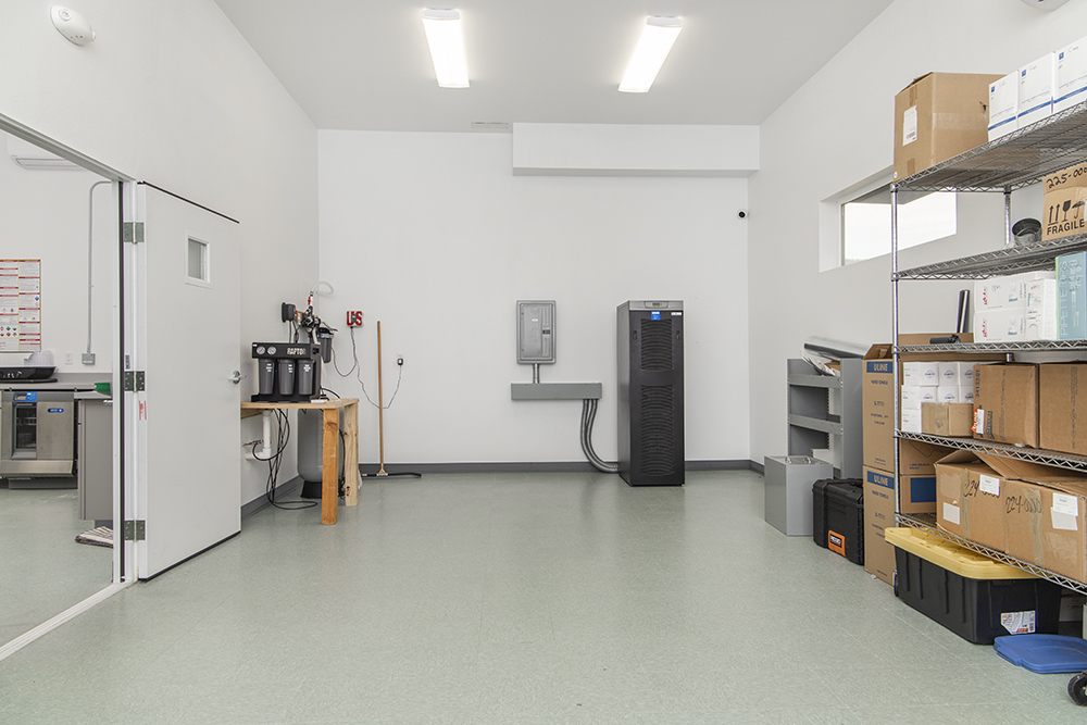 Spacious interior of the commercial building with tiled flooring, ductless HVAC, and flexible open workspace.