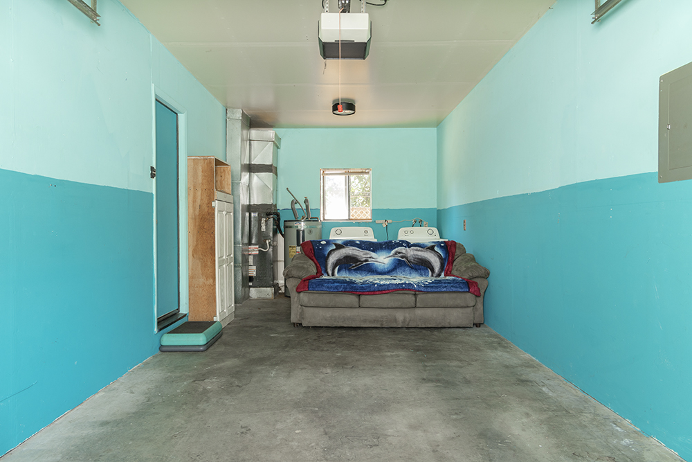 Attached one-car garage with interior access and storage space.