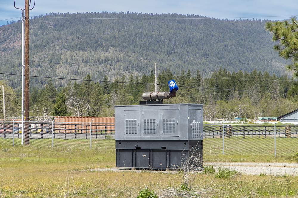 Commercial-grade diesel backup generator installed outside the main building at 30073 Redwood Hwy.