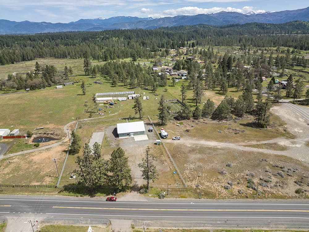 Aerial view showing 30073 Redwood Hwy with direct frontage on Highway 199, highlighting road visibility and commercial access.