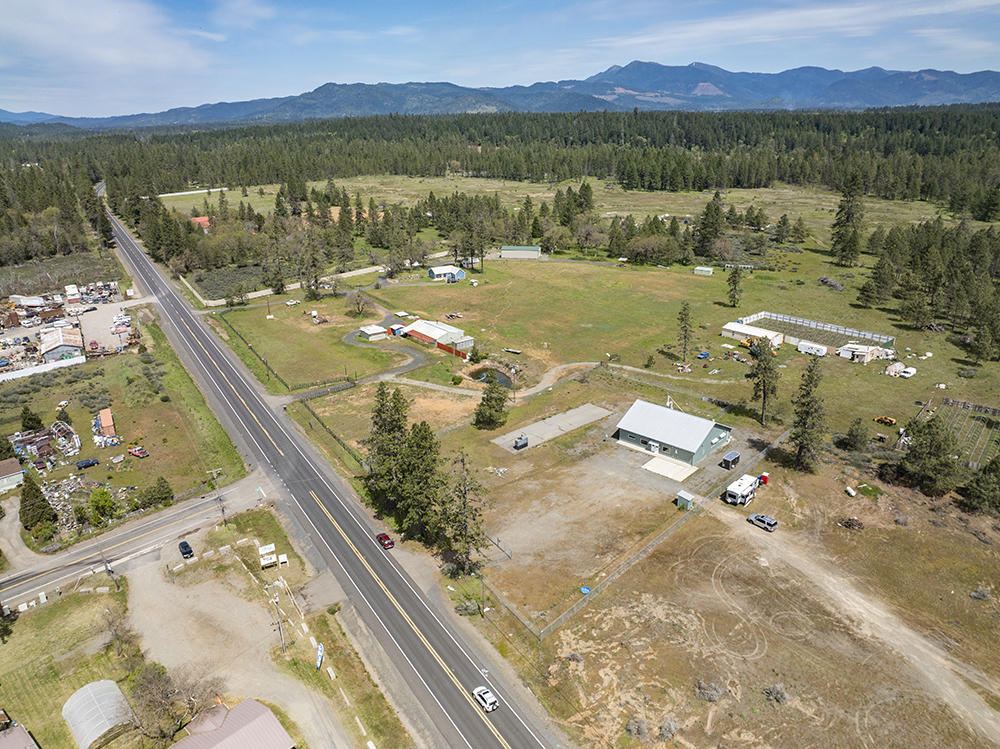 Aerial view showing 30073 Redwood Hwy with direct frontage on Highway 199, highlighting road visibility and commercial access.