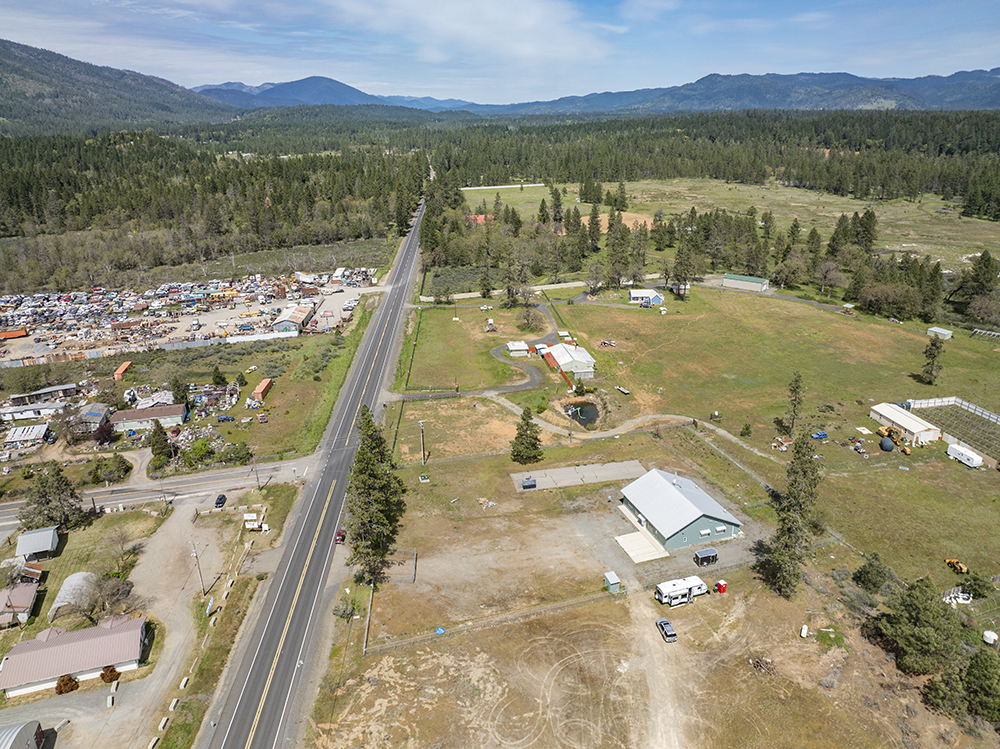 Aerial view showing 30073 Redwood Hwy with direct frontage on Highway 199, highlighting road visibility and commercial access.