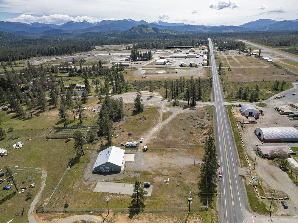Aerial view showing 30073 Redwood Hwy with direct frontage on Highway 199, highlighting road visibility and commercial access.