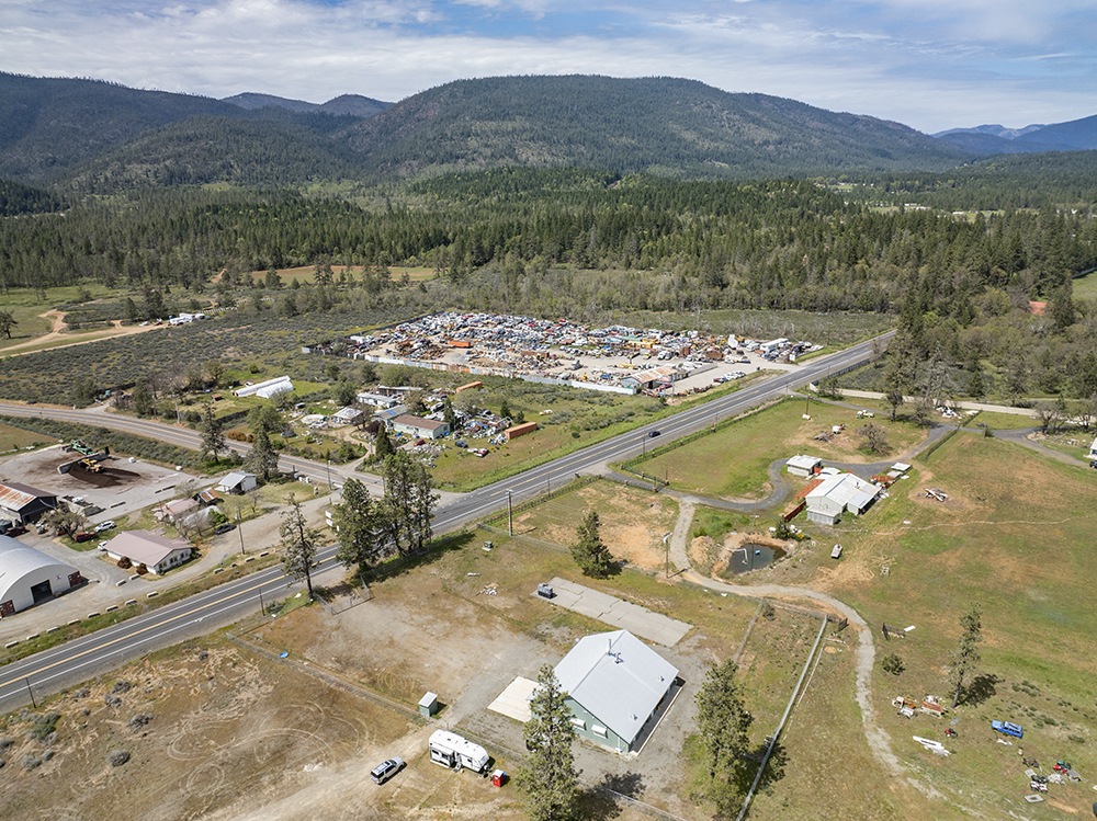 Aerial view showing 30073 Redwood Hwy with direct frontage on Highway 199, highlighting road visibility and commercial access.