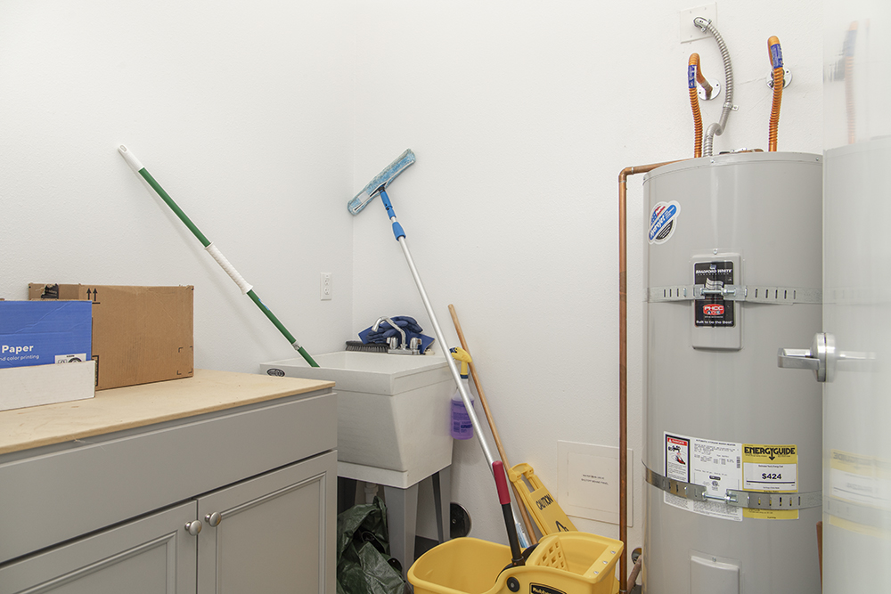 Well-lit utility room with electrical panels, HVAC components, and industrial-grade mechanical systems.